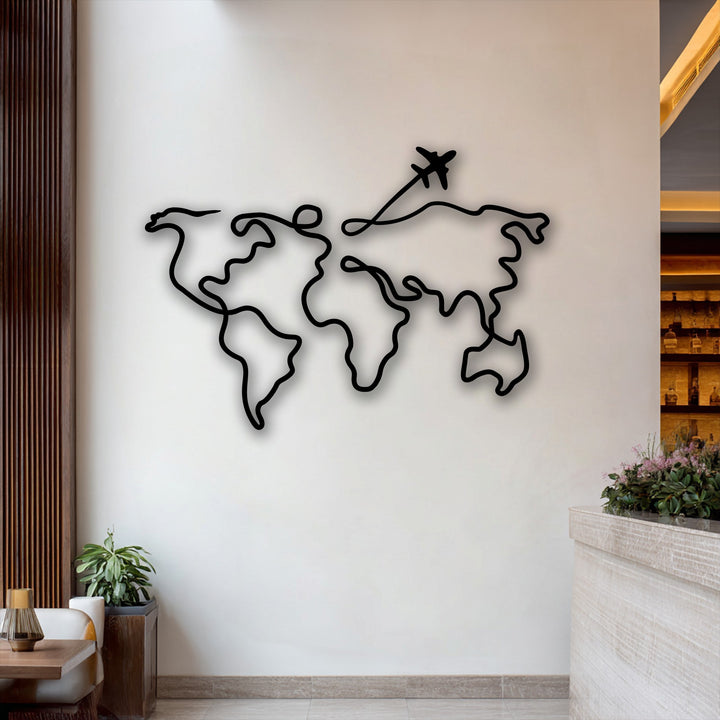 The pristine white wall is strikingly adorned with a sleek black metal artwork depicting a minimalist world map, complete with an airplane detail.