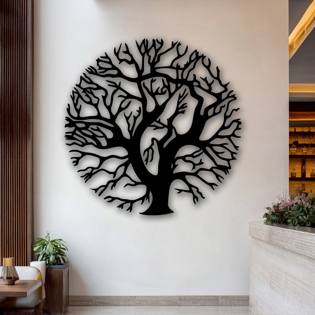 The soft texture of fresh pink flowers beautifully complements the intricate silhouette of the round Tree of Life decorative metal art.