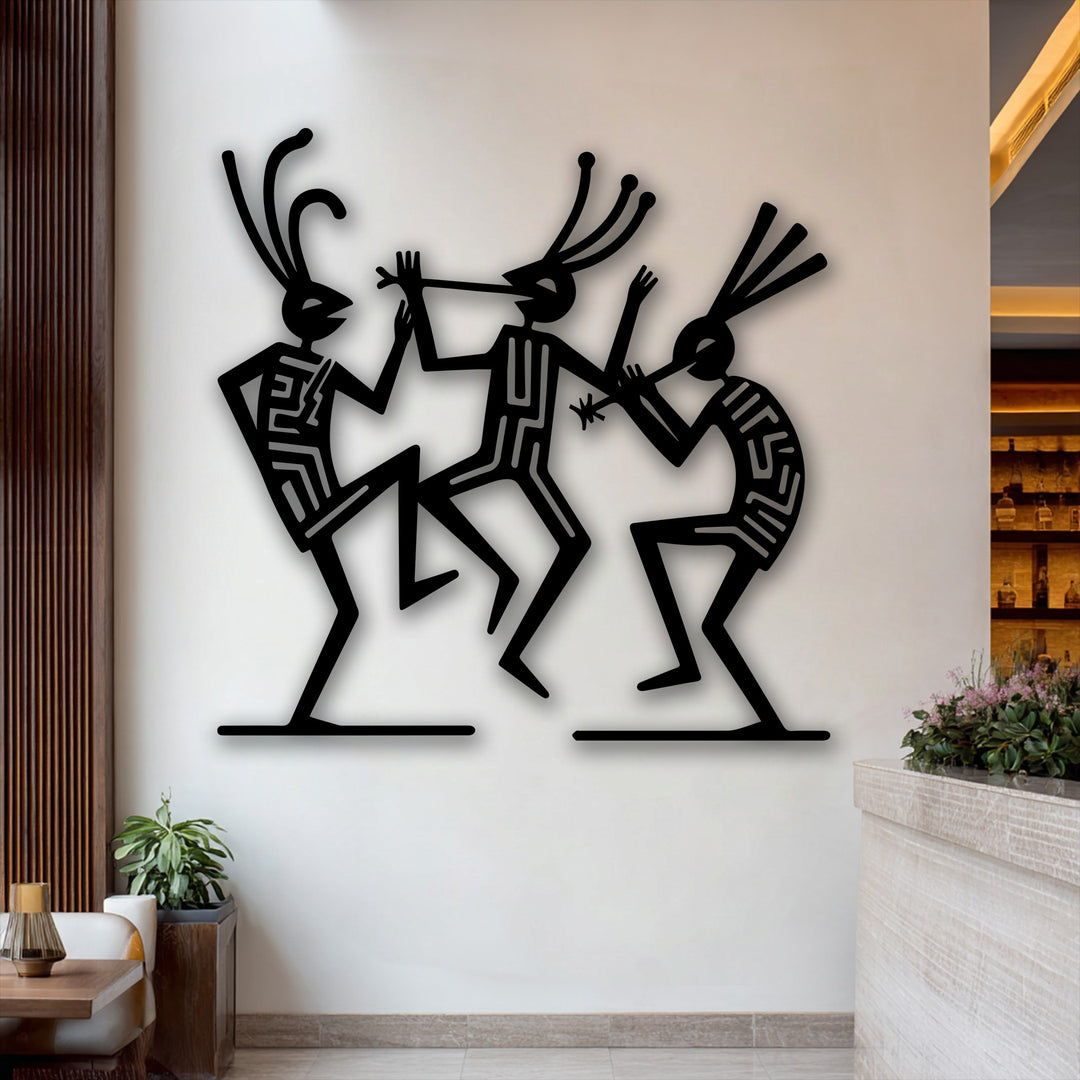 A sleek wooden table, potted plant, and textured counter highlight the elegant tribal dance figures decorative metal art.