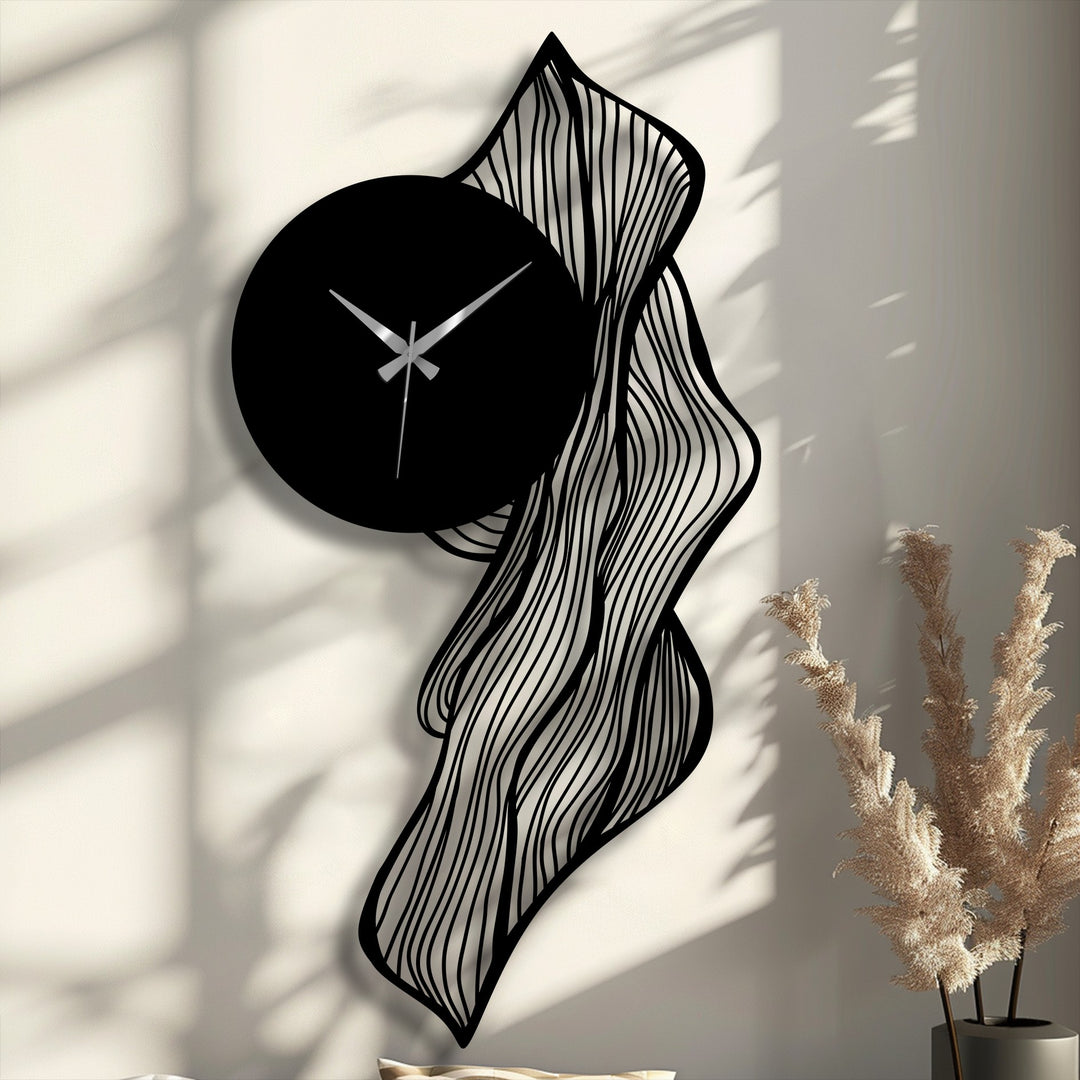 The darkest area showcases a sleek black circular clock face with silver hands, integrated into a flowing abstract leaf unique metal wall art design.