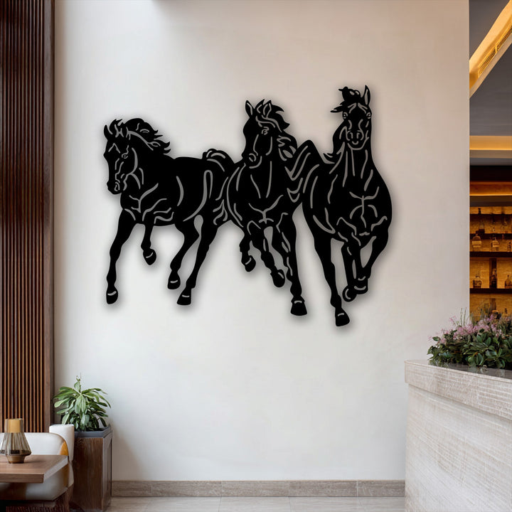 The realistic detail of a unique metal wall art featuring three dynamic galloping horses, their powerful forms and motion vividly captured.