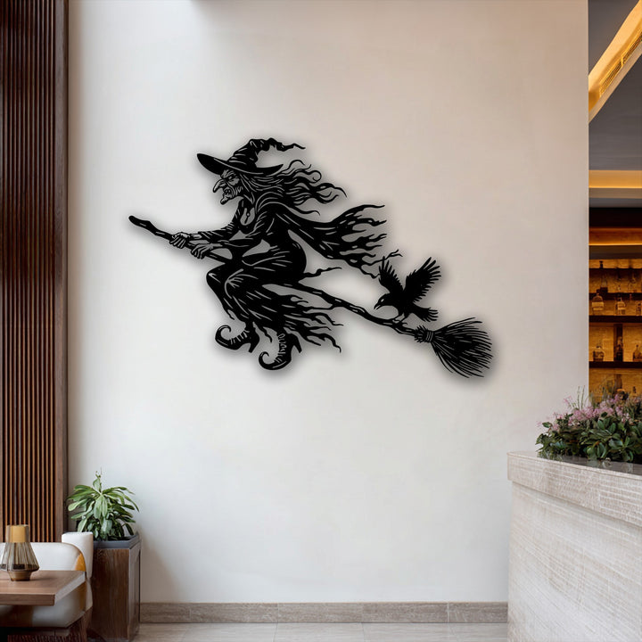 This metal artwork vividly portrays the exhilarating, sweeping movement of a witch flying on her broomstick with a raven.