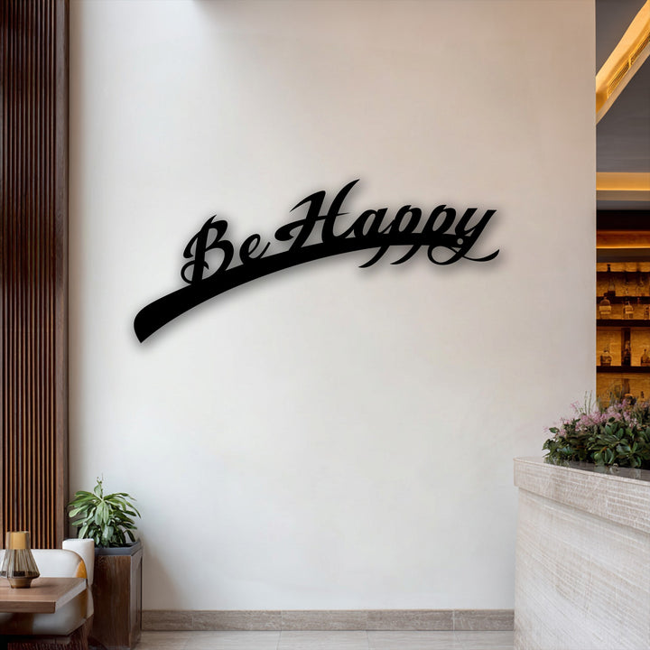 Organic forms of the elegantly flowing 'Be Happy' script, alongside lush green plants, define this stylish inspirational metal wall decor.