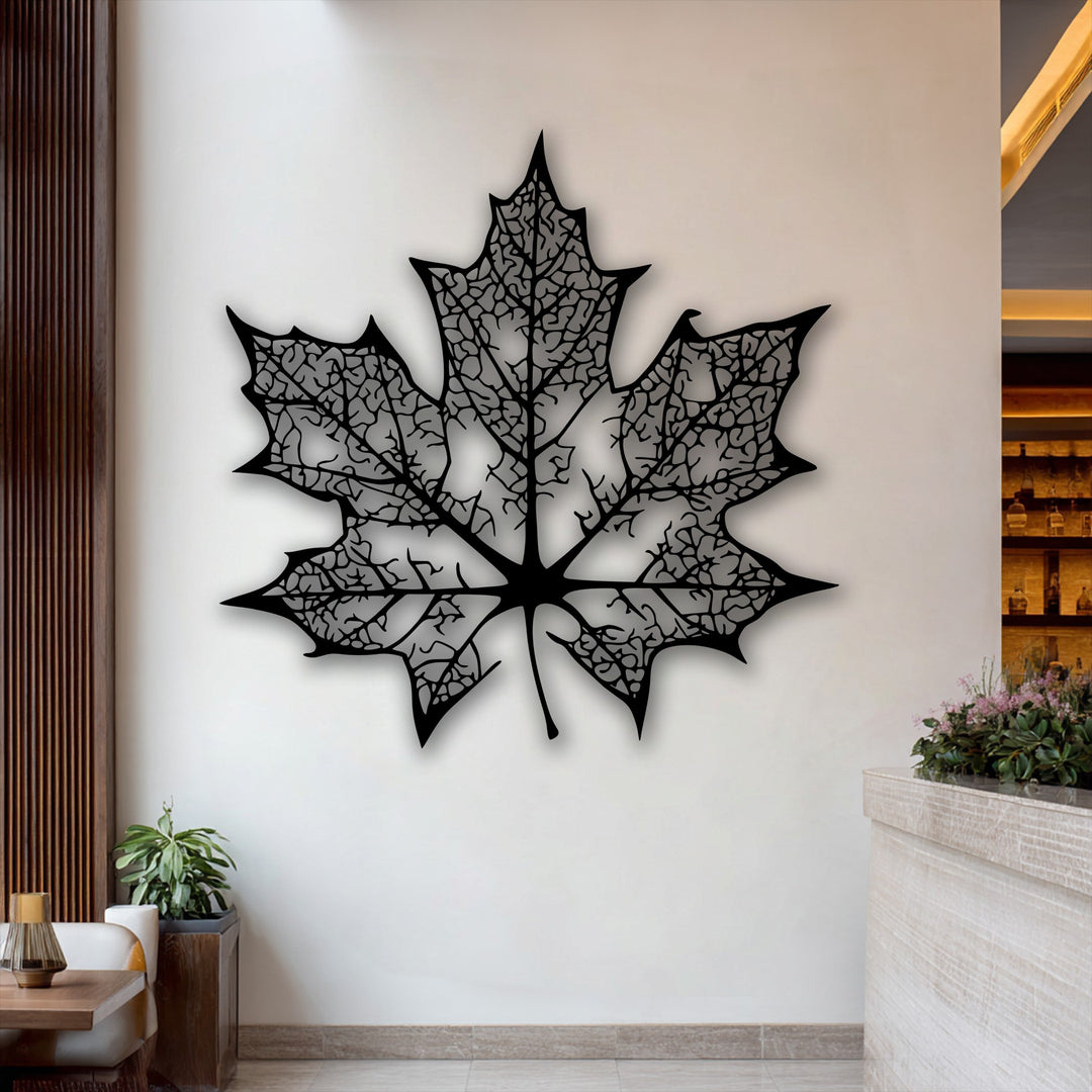 The bright background wall with wooden accents and a counter subtly enhances the intricate maple leaf decoration wall art.