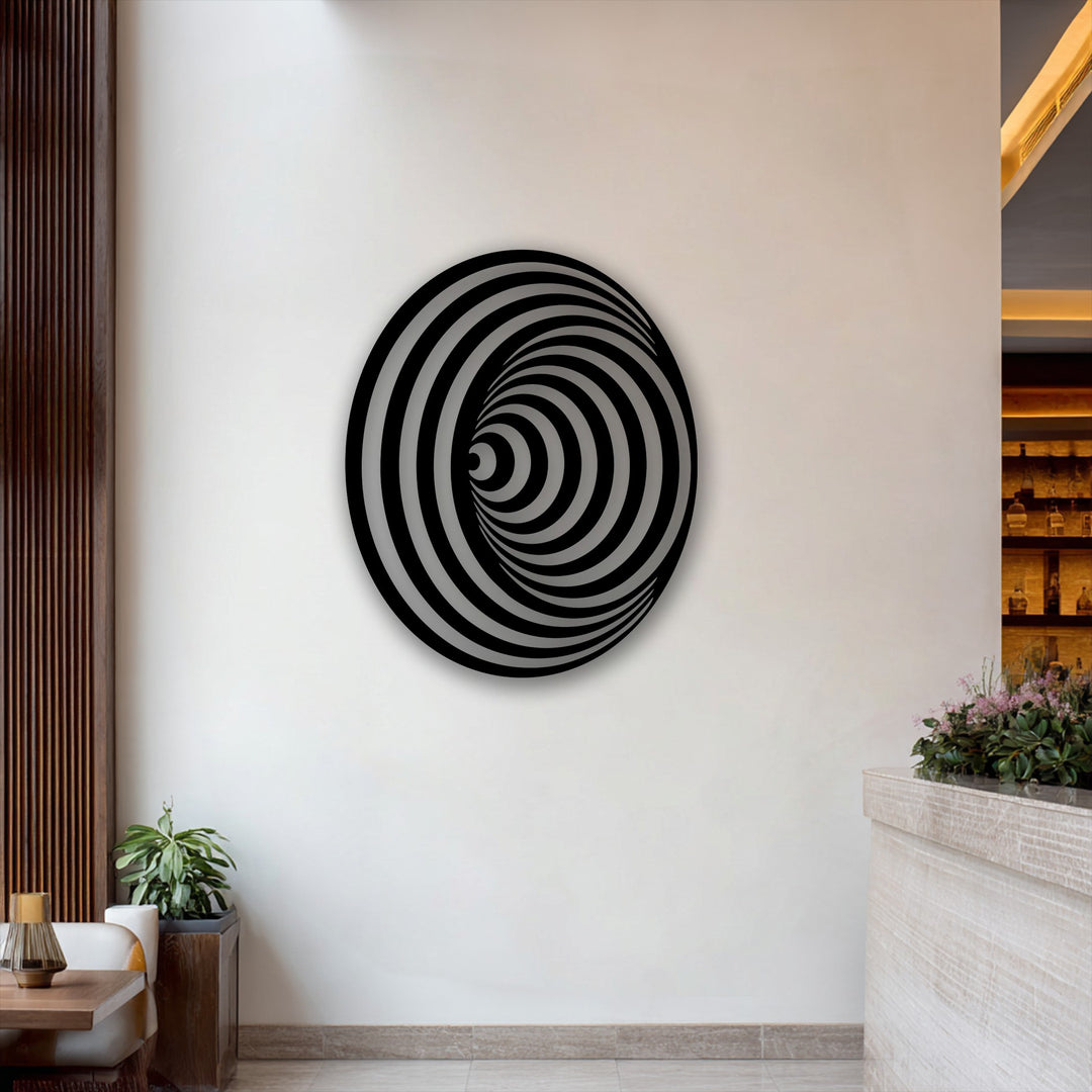 A perfectly centered circular metal wall decor featuring a hypnotic black and gray spiral geometric illusion design.