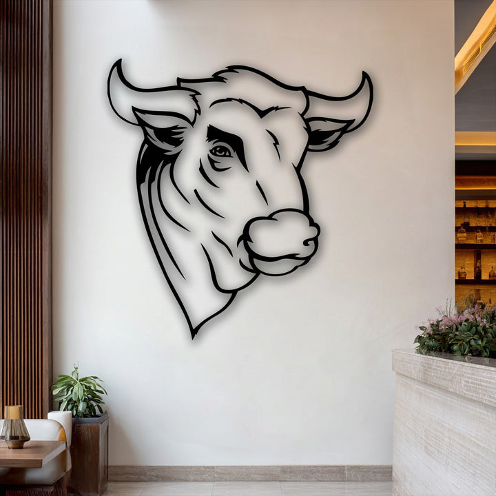 Creamy white wall featuring a sleek black outline of a rustic bull head, an impactful piece of metal art for wall decor.