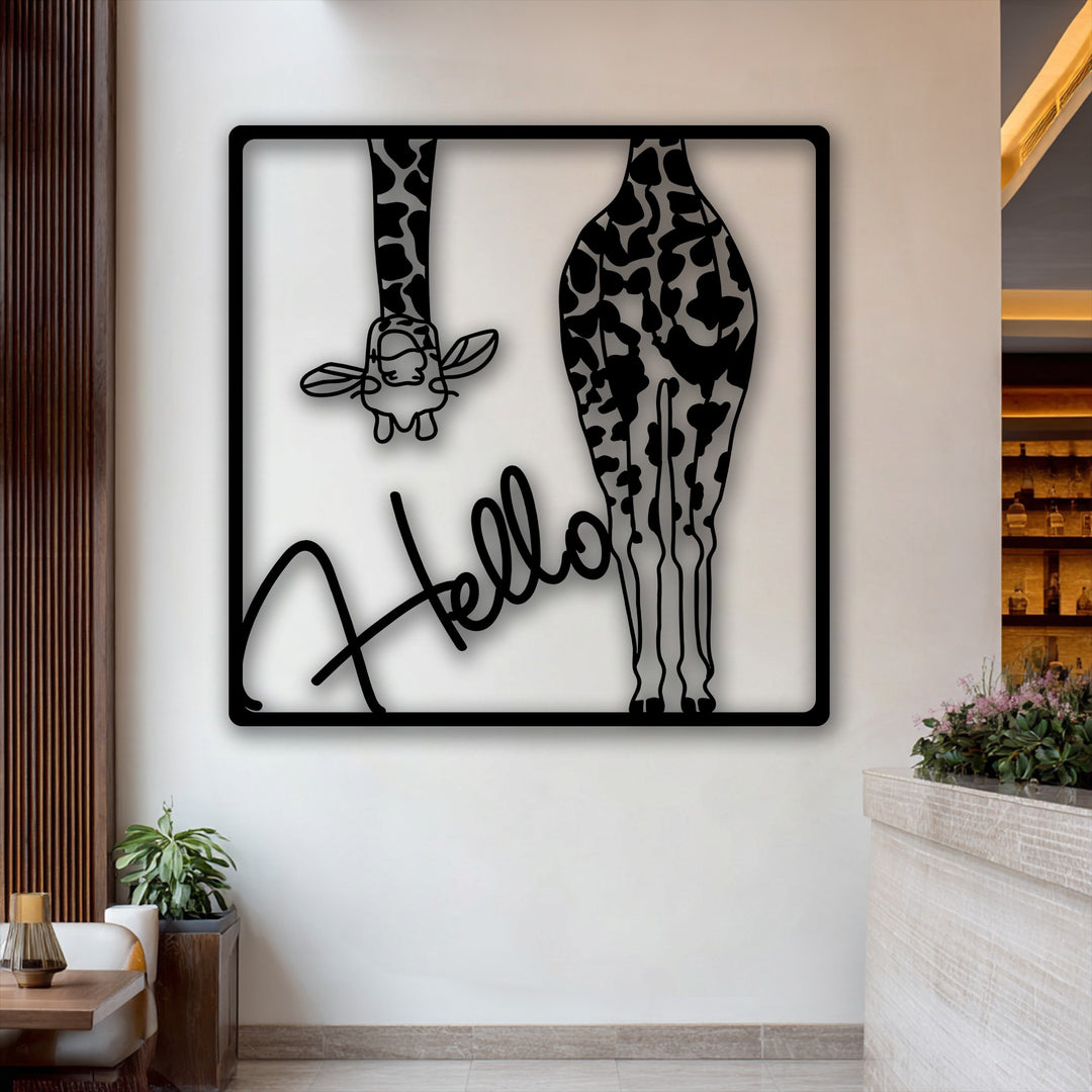 The distinct play of light and shadow highlights the intricate black 'Hello Giraffe' metal wall decor against a pristine white wall.