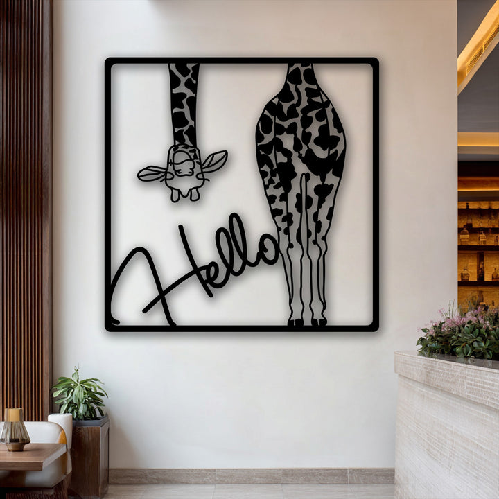 The distinct play of light and shadow highlights the intricate black 'Hello Giraffe' metal wall decor against a pristine white wall.