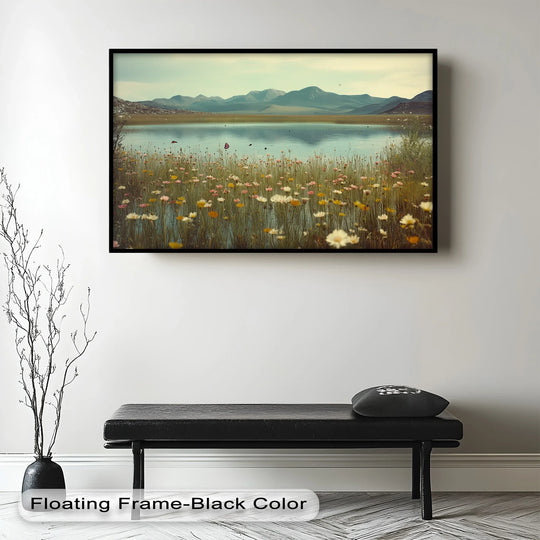 Warm hues of yellow and white in the wildflowers contrast the cool color temperature of the lake and mountains in this framed oil painting reproduction print.