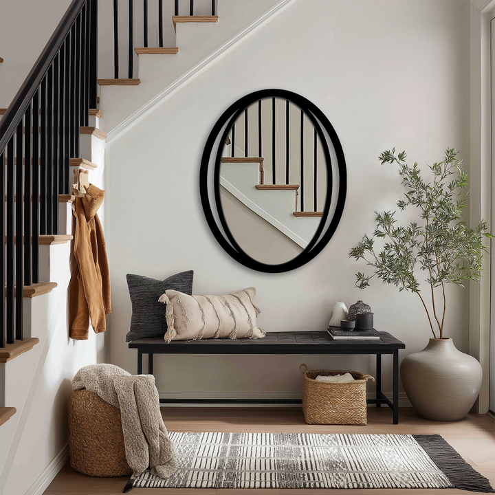 Reflecting the staircase and light fixture, the sleek modern dual frame of the Double Eclipse oval mirror for wall decor becomes the focal point.