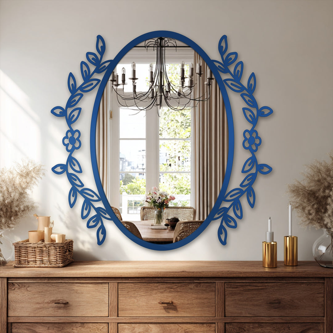 Darkest area highlights the botanical floral frame on this oval modern mirror, offering a decorative metal art accent to a home's interior.