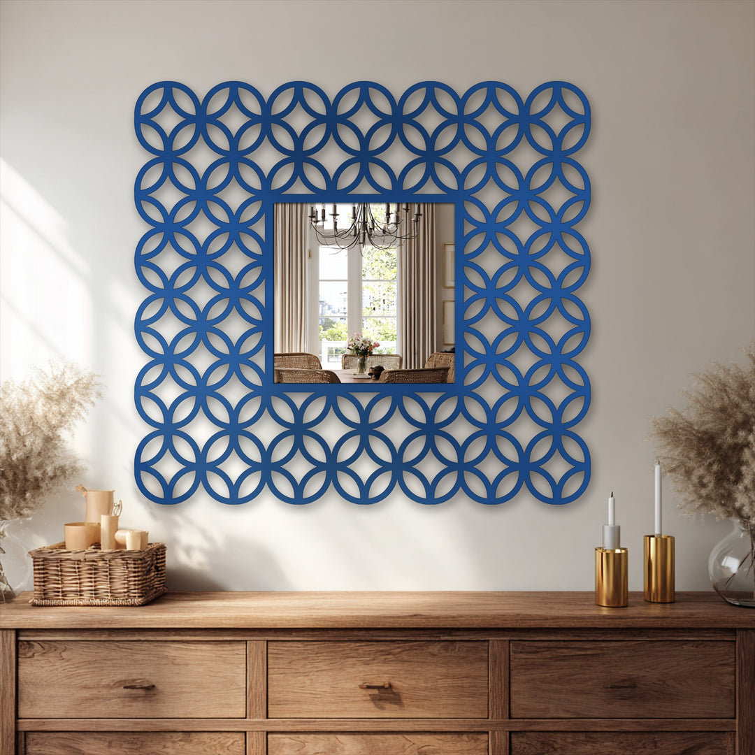 Brightest area illuminates the decorative framed interlocking ring pattern square bathroom mirror, accentuating its elegant design and modern aesthetic as stylish home decoration.