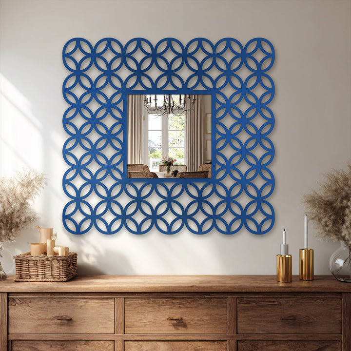 Brightest area illuminates the decorative framed interlocking ring pattern square bathroom mirror, accentuating its elegant design and modern aesthetic as stylish home decoration.