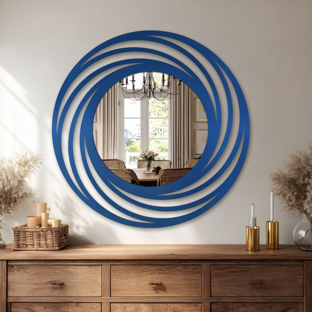 Depth and layers in this decorating with wall mirrors is created by the swirling ring frame of this round mirror, lending a modern focal point.