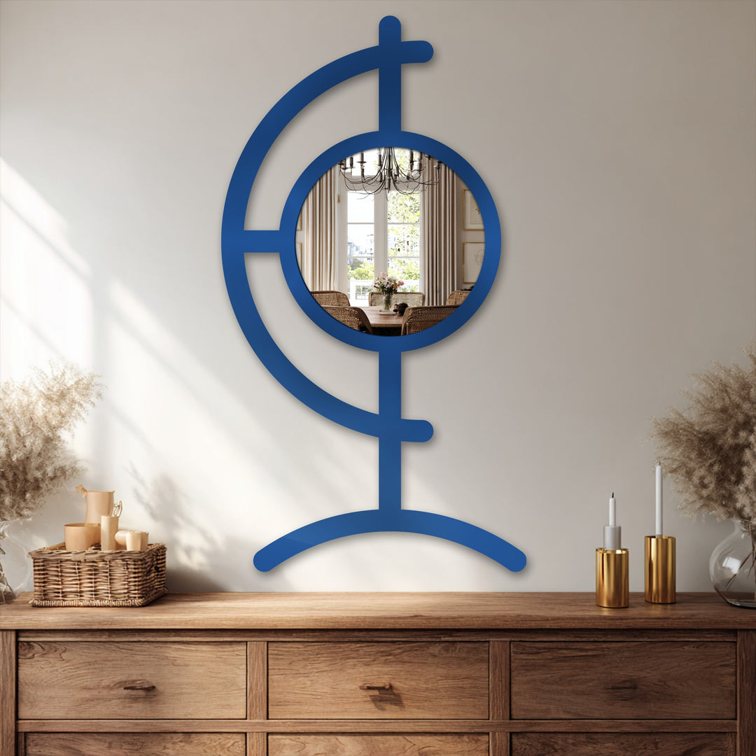 Negative space highlights the orbit line design of this striking blue bathroom mirror, creating a sculptural focal point with its metal frame and circular reflective surface.