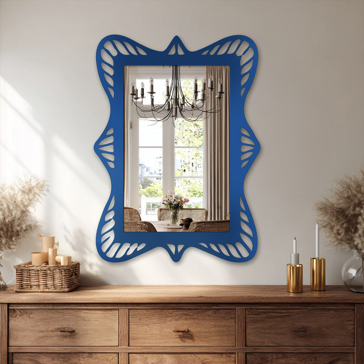 Subtle light and shadow play across this ornate wave frame bathroom mirror, an artistic metal wall decor piece with a unique, sculpted black rectangular design.