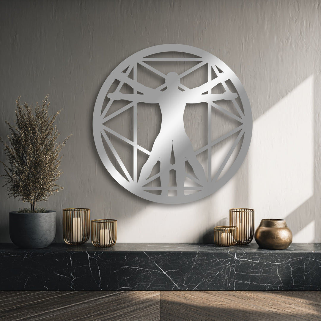 The soft glow of sunlight gently illuminates the textured wall behind the Vitruvian Man geometric metal art for wall.