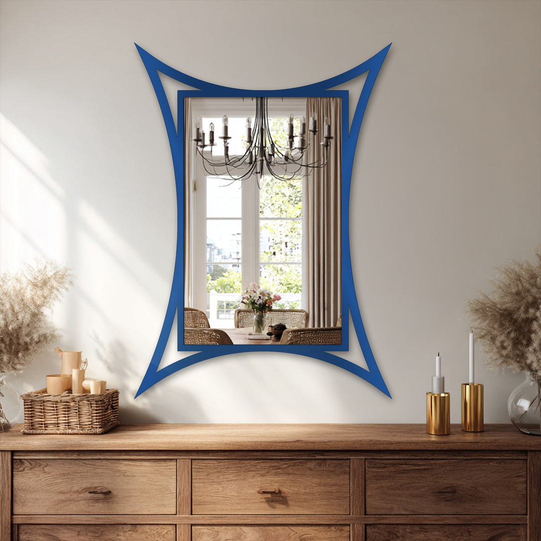 The curved edge of this sculptural framed metal artwork reflects a dining room scene, a modern mirror adding an elegant statement to home decor.