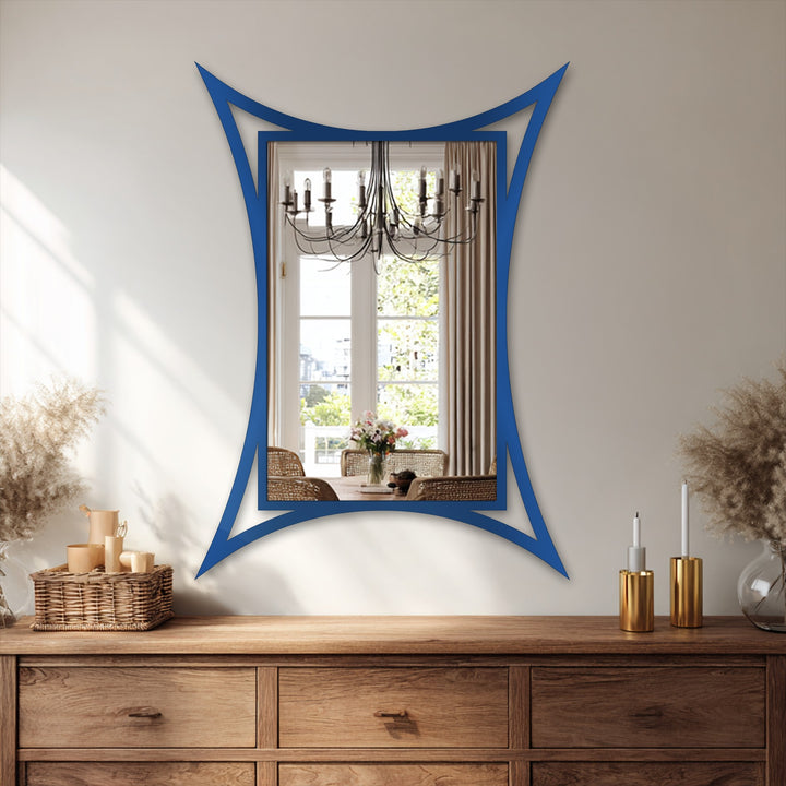 The curved edge of this sculptural framed metal artwork reflects a dining room scene, a modern mirror adding an elegant statement to home decor.