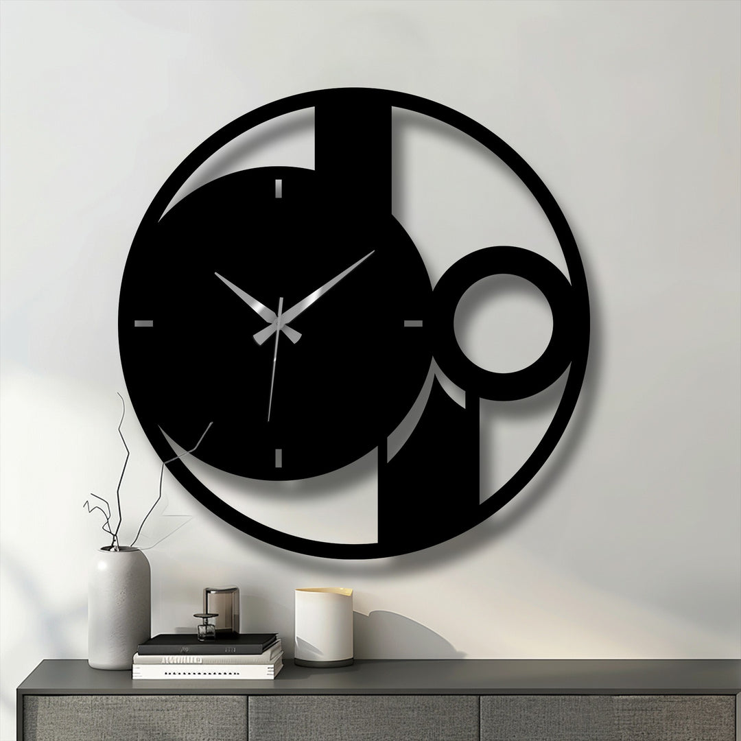 Depicting the darkest area of the abstract minimal circle metal art for wall, this contemporary clock casts dramatic shadows on the clean, white wall.