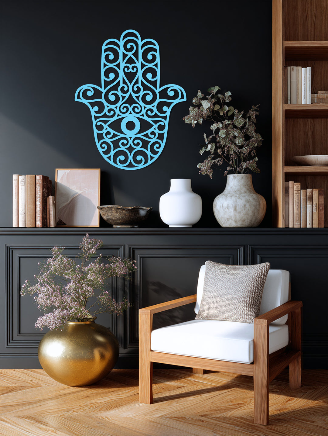 Intersecting geometric patterns form a hamsa hand in this striking example of metal wall decor, showcasing sharp lines and spiraling shapes around a central eye.