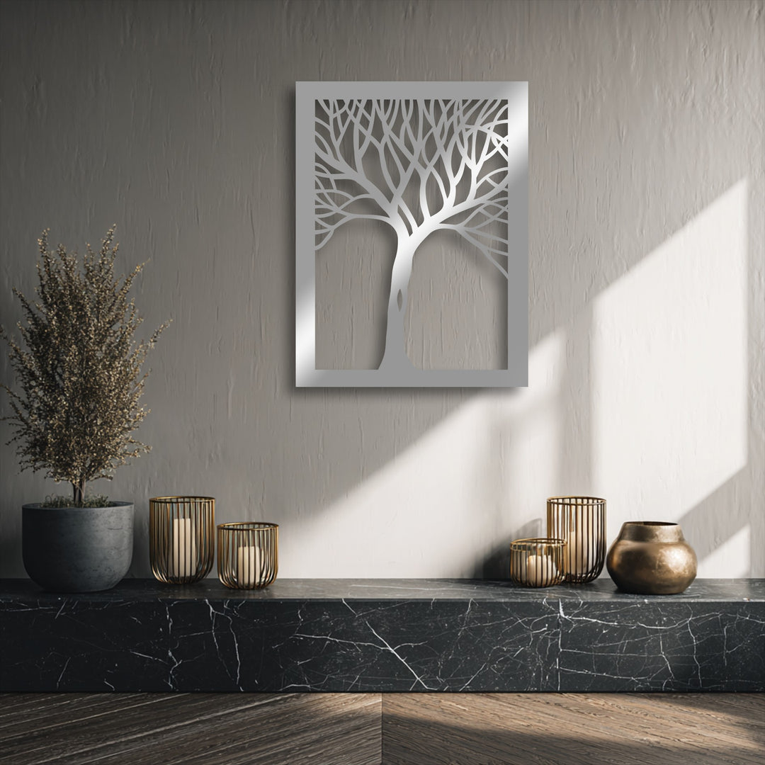 The warm color temperature highlights the intricate abstract tree silhouette metal wall decor, contrasting with cool wall tones and casting inviting shadows.