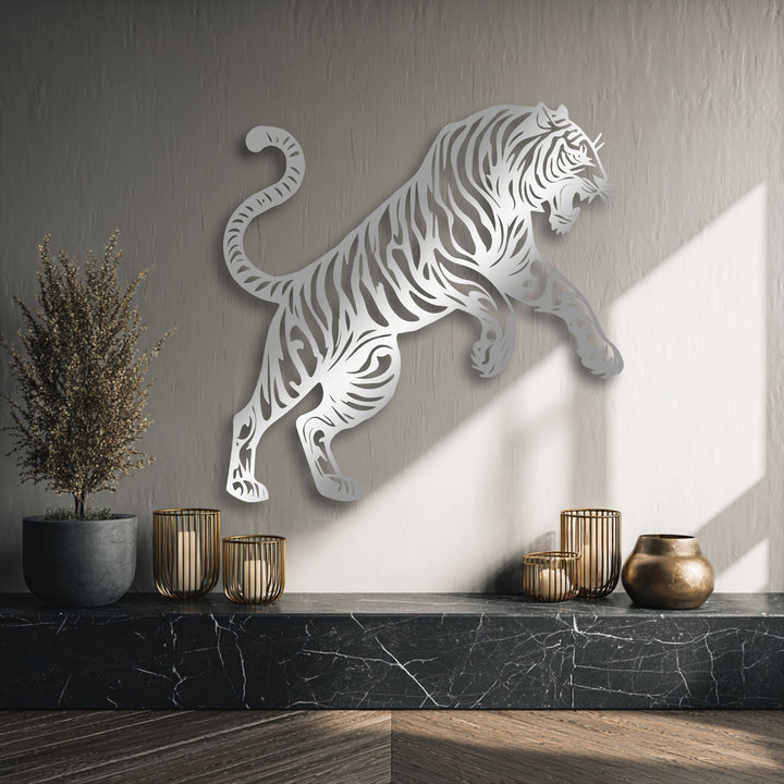 Striking color contrast between the shimmering silver tiger metal wall decor and the textured dark gray wall, accentuated by bright sunlight.
