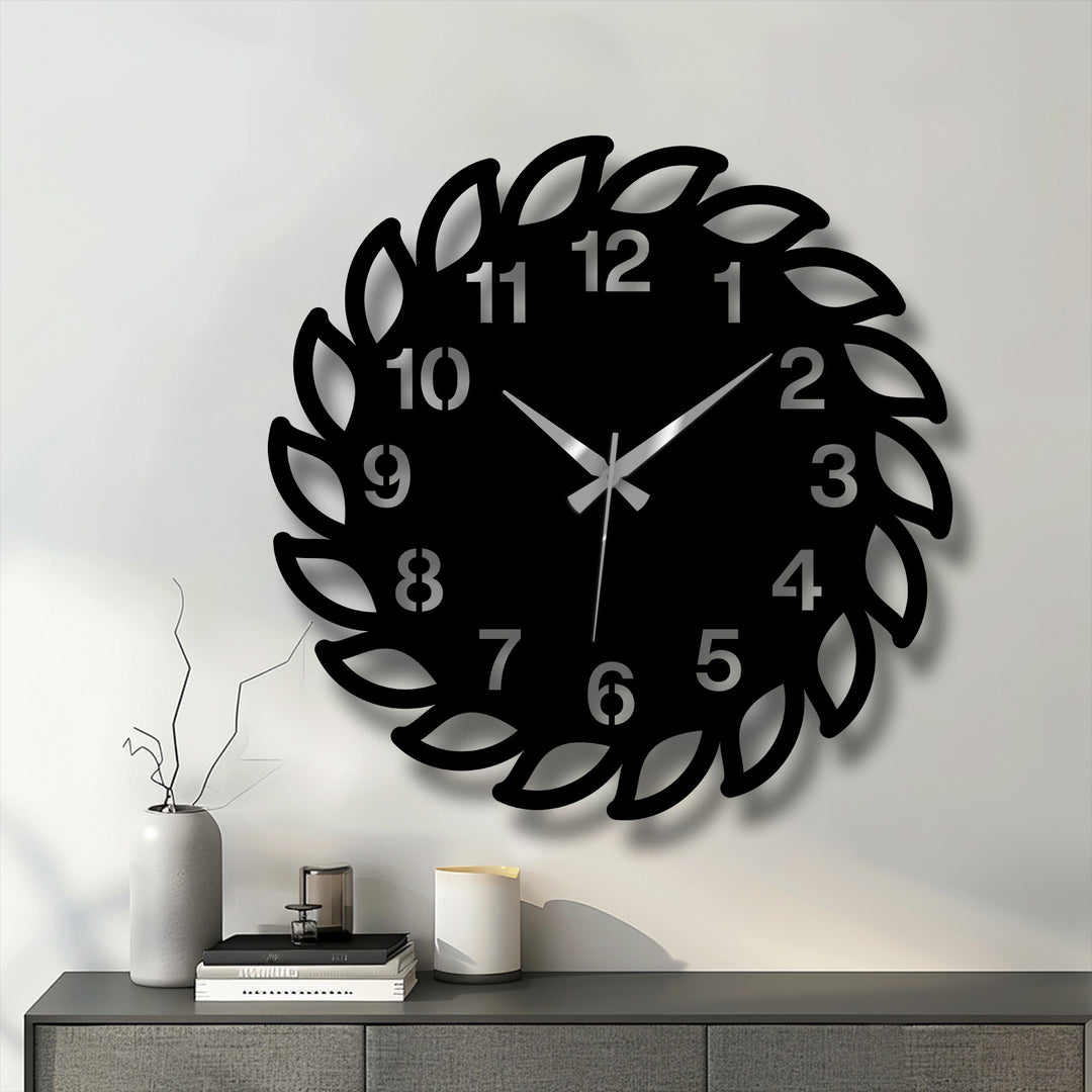 Low color saturation enhances the modern, black leaf frame of this decorative metal art wall clock, creating a sophisticated and minimalist aesthetic.