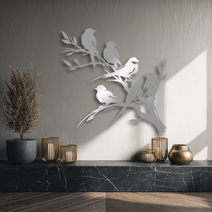 The superior material quality of this unique metal wall art showcases finely crafted birds on a branch with a striking metallic sheen.