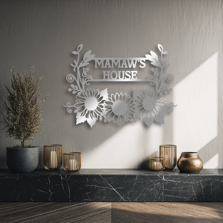 The sweeping floral motifs and three vibrant sunflowers create inviting organic forms in this personalized sunflower family name metal wall decor.