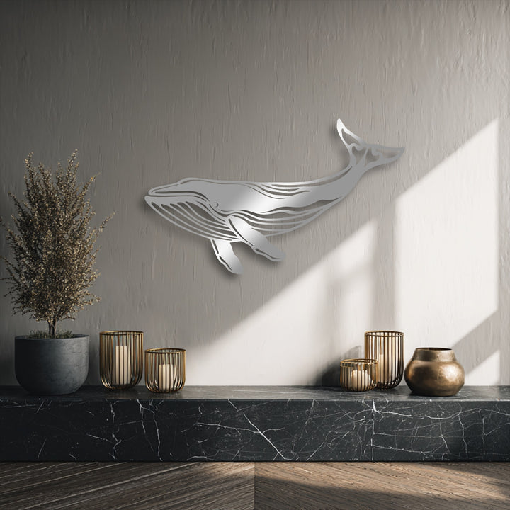 Soft greige dominates, featuring a majestic silver whale metal art for wall above a striking black marble shelf.