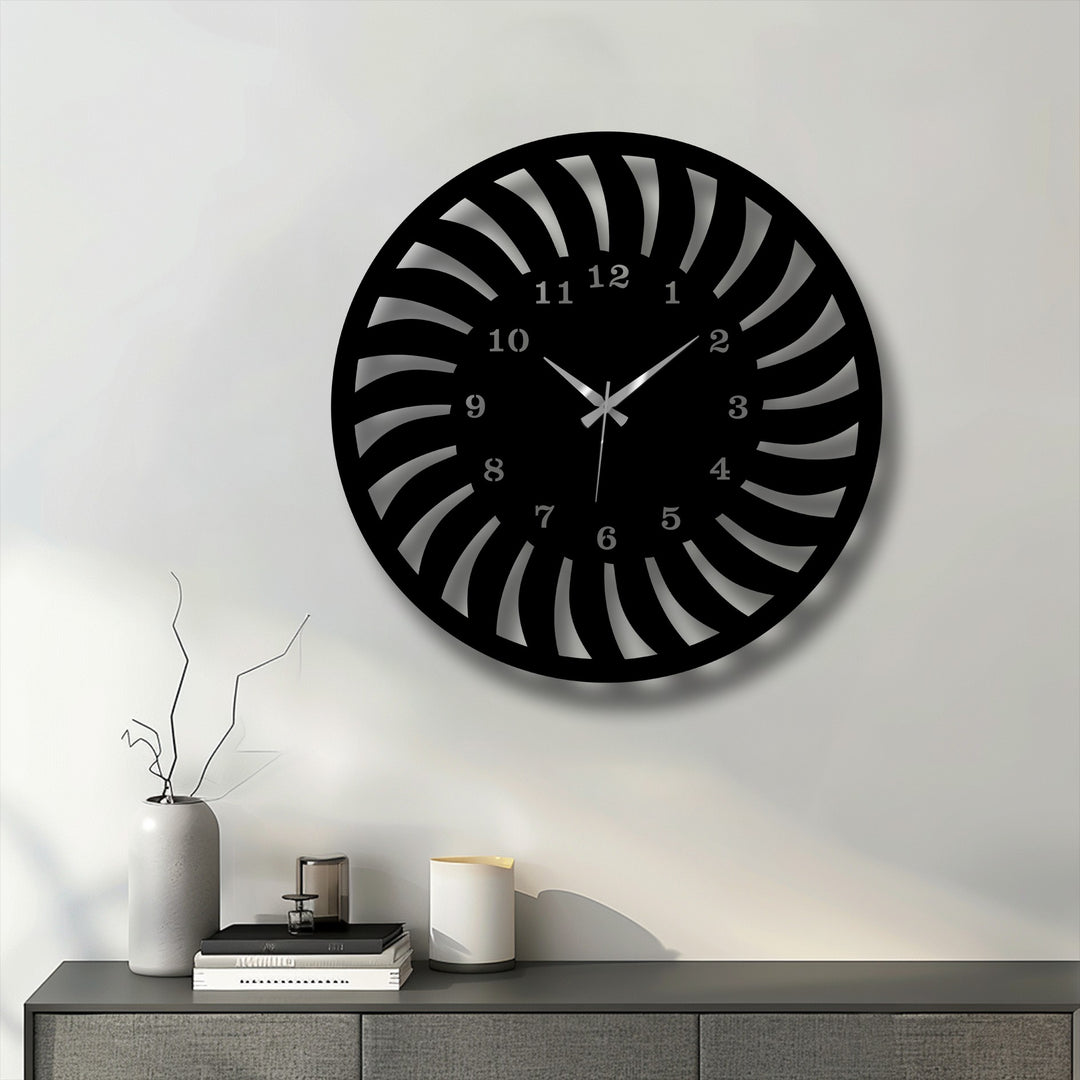 Geometric radial spiral design defines this unique metal wall art clock, featuring elegant cutouts that form a captivating pattern.