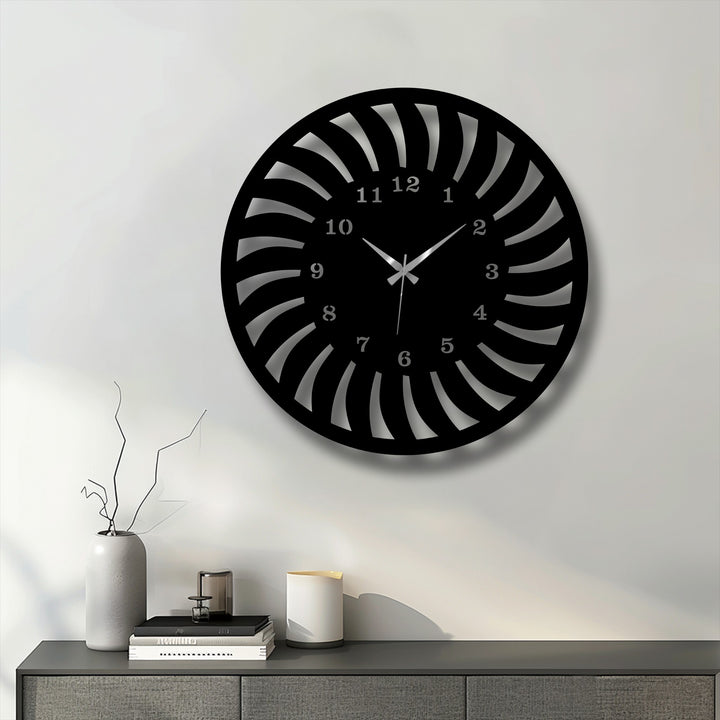 Geometric radial spiral design defines this unique metal wall art clock, featuring elegant cutouts that form a captivating pattern.