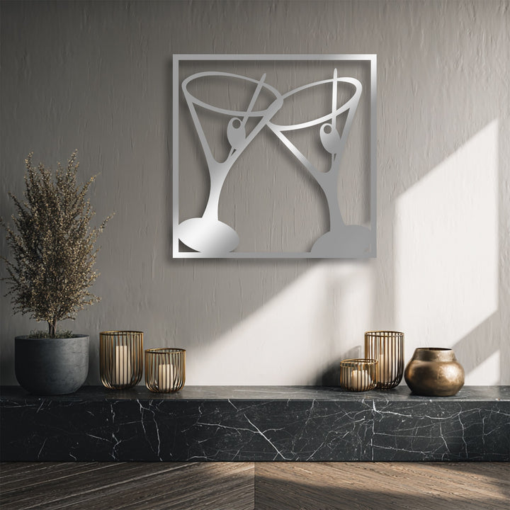 The textured, muted gray background wall subtly highlights the stylish Cheers Cocktail Glasses metal art for wall, featuring a clinking martini design.
