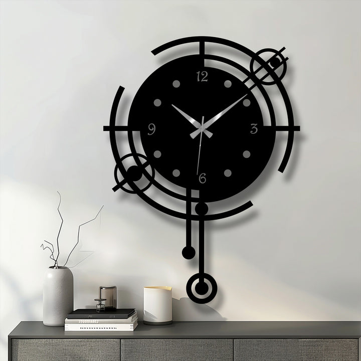 The warm color temperature emphasizes the sleek black modern orbit geometric metal artwork wall clock against a cooler, brighter wall.