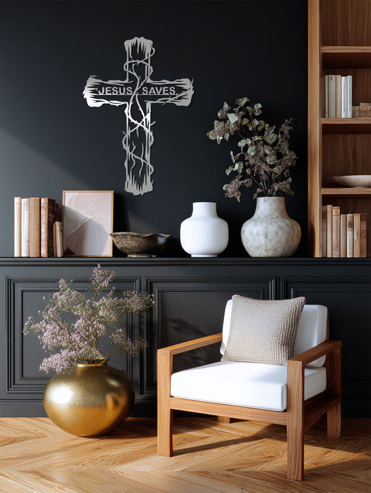 Showcasing a decorative metal art cross with 'Jesus Saves' inscription, the layering effect emphasizes its delicate, openwork design against the dark wall and shelf decor.