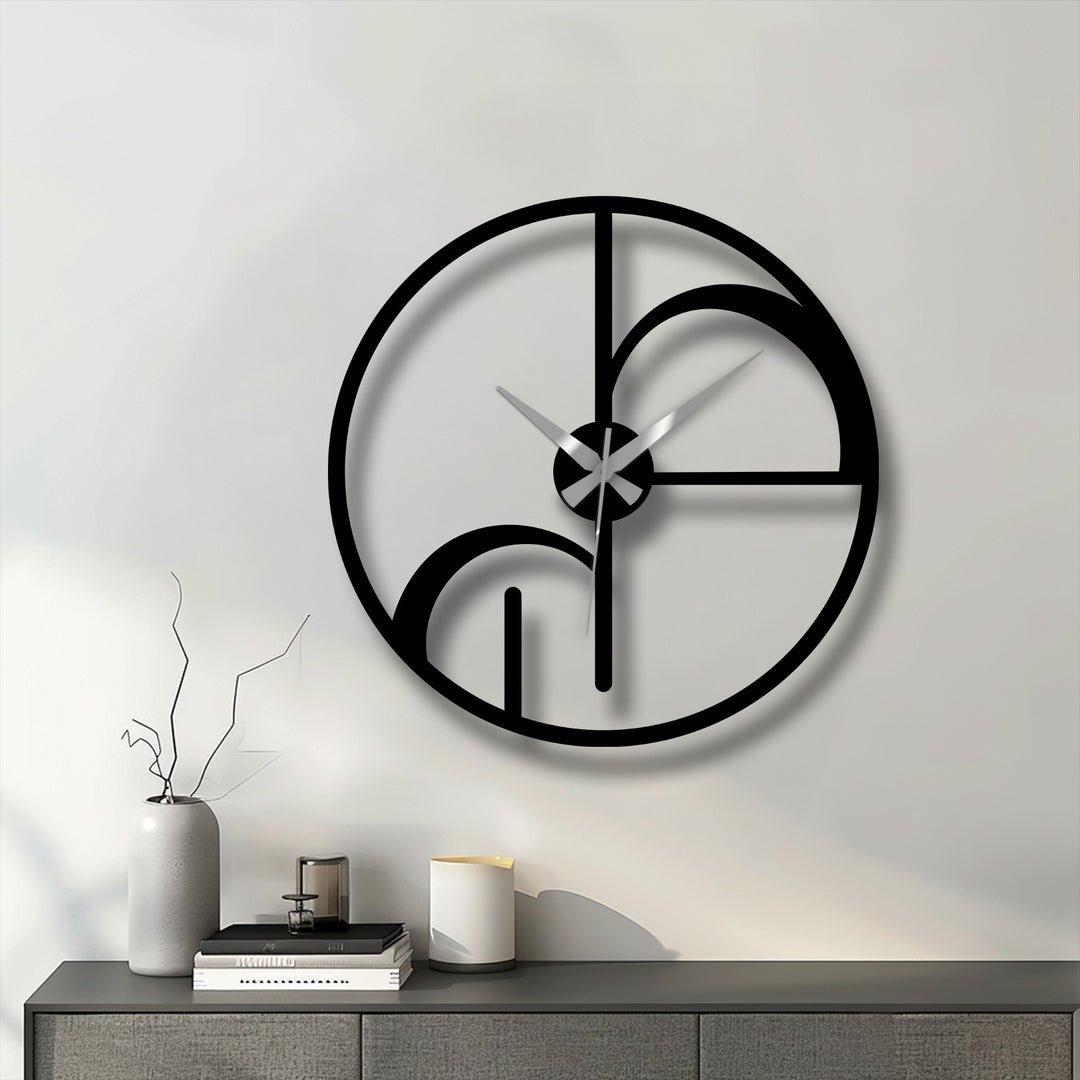 The black metal abstract clock's edge and borders feature a modern, geometric, decoration wall art design in a round shape.