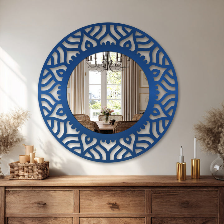 The decorative mirror's brightest area highlights a stylish reflection of a dining room scene within an abstract pattern round frame, a modern statement in decoration wall art.