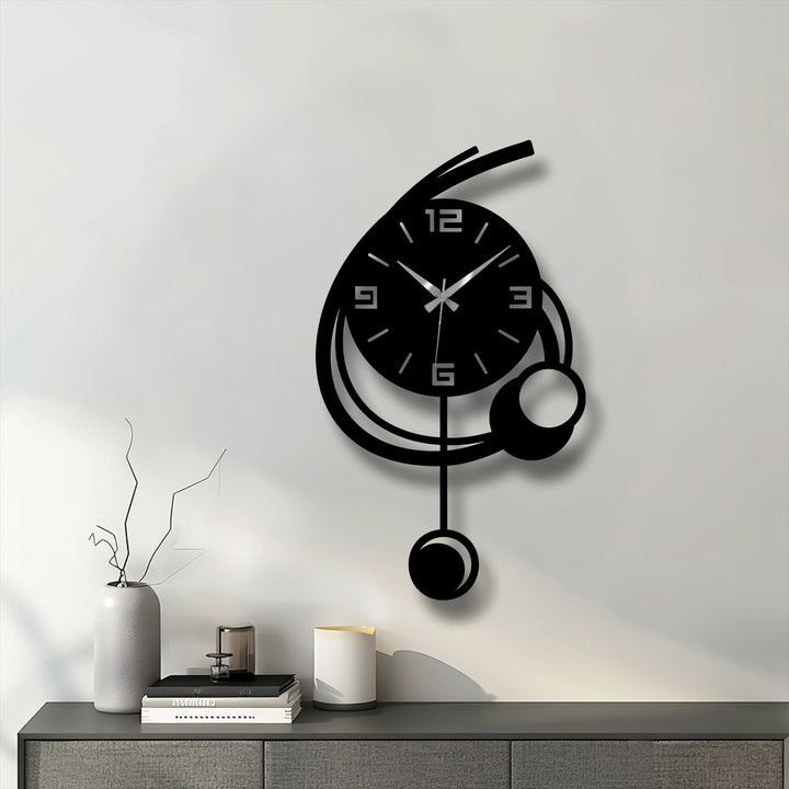 Subtle light and shadow define the minimalist geometric form of this modern orbit pendant metal artwork wall clock, casting delicate shadows on the wall.