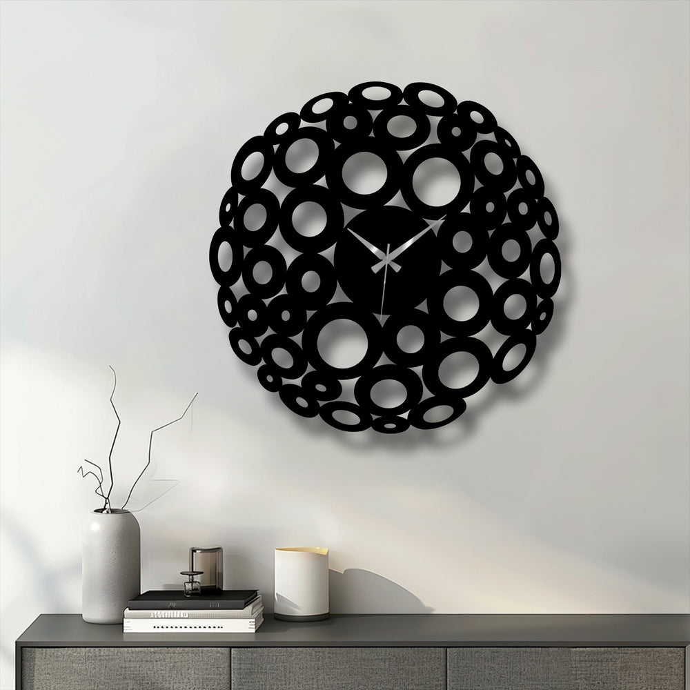Cool color temperature highlights the chic black bubble circle decorative metal art clock against a neutral wall, creating a contemporary statement.