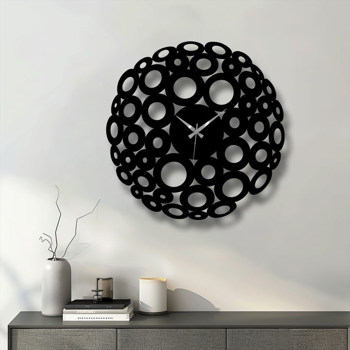 Cool color temperature highlights the chic black bubble circle decorative metal art clock against a neutral wall, creating a contemporary statement.