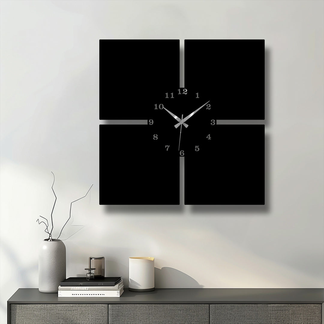 The stark contrast from the black minimal panels of this decorative metal art wall clock to the crisp white wall is striking, highlighted by sleek silver numbers and hands.