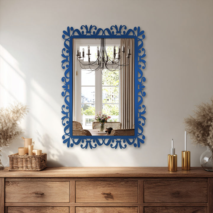 Fluid, leafy shapes define the scroll frame of this modern wall mirrors, reflecting an inviting scene of a dining room bathed in natural light.