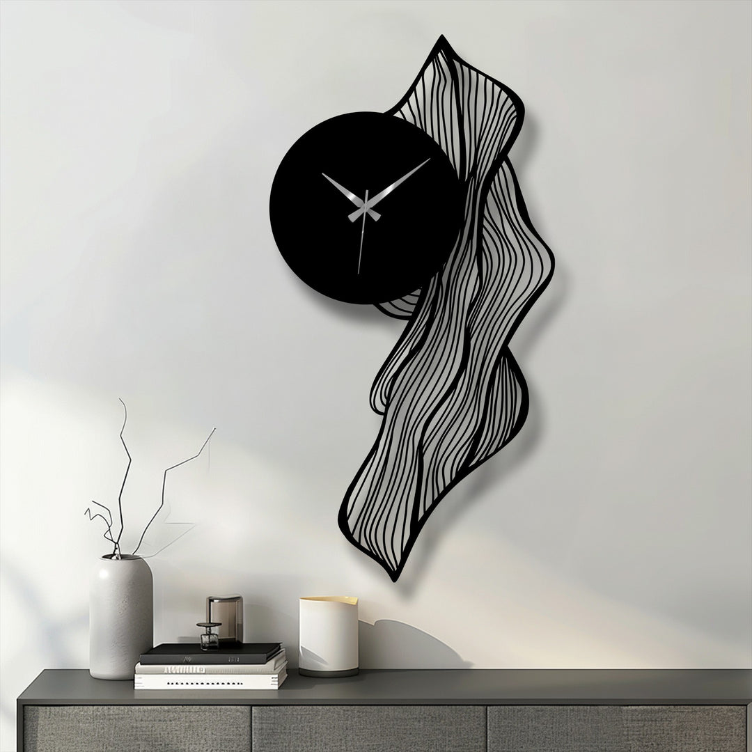Evoking an abstract quality, the flowing lines and unique shape of this metal art for wall clock present a modern, artistic wall decor piece.