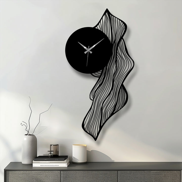 Evoking an abstract quality, the flowing lines and unique shape of this metal art for wall clock present a modern, artistic wall decor piece.