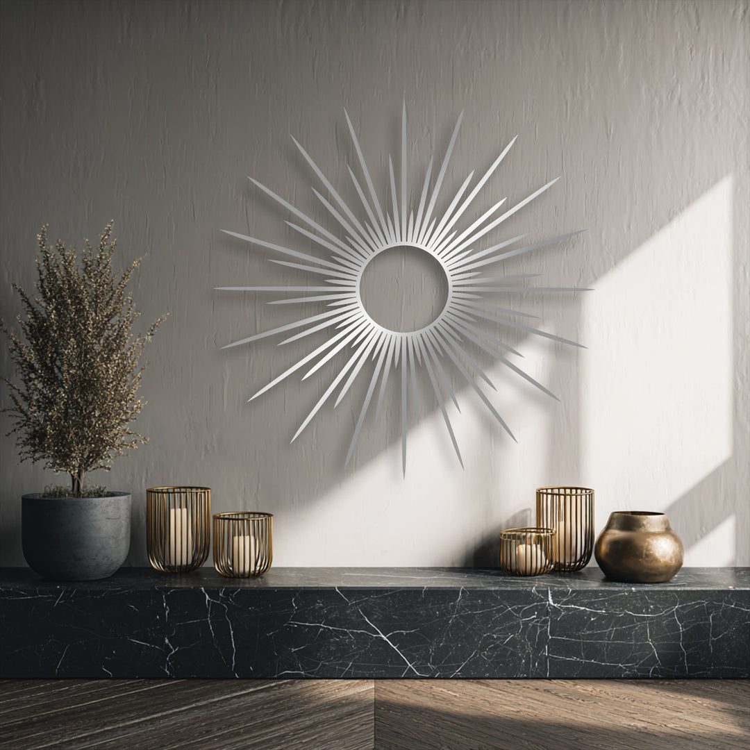 The striking abstract quality of this modern metal artwork features a radiant sunburst design with sleek, geometric lines.