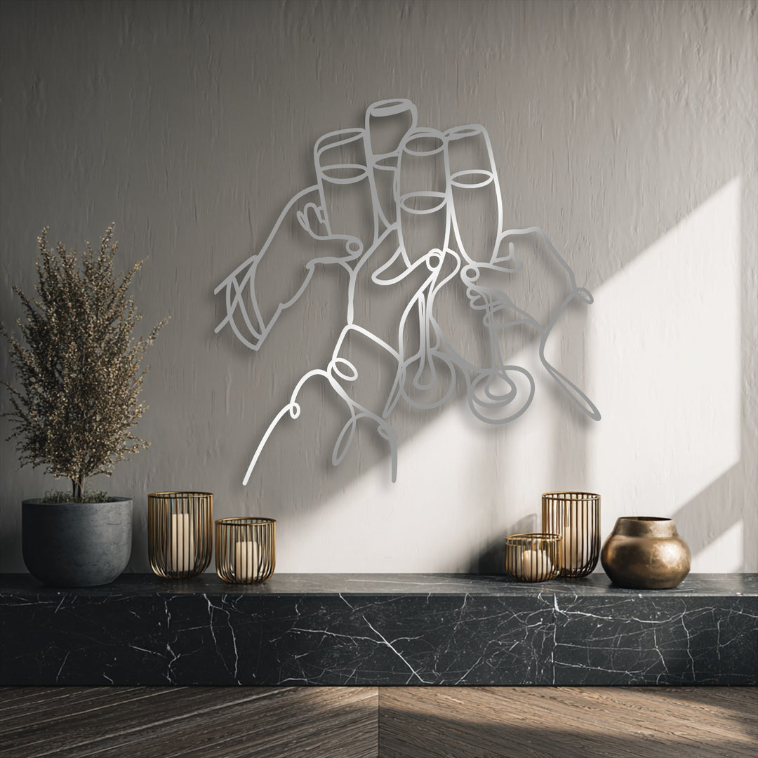 The captivating focal point is the 'Cheers Moment' silver line metal art for wall, showing hands toasting champagne glasses.