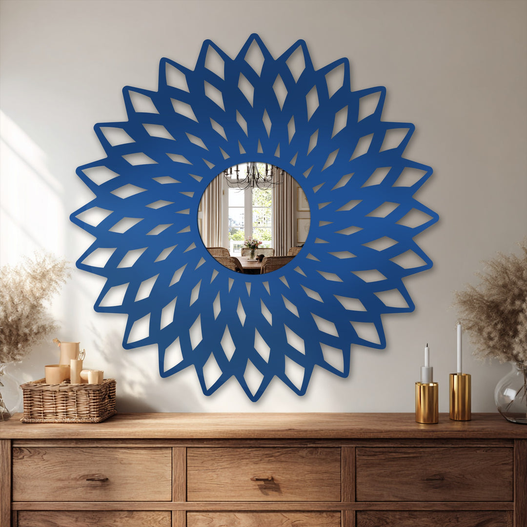 Intricate wooden dresser shows the detailed foreground of a modern, geometric flower-shaped framed wall mirror reflecting a dining area, offering a unique metal wall art accent.