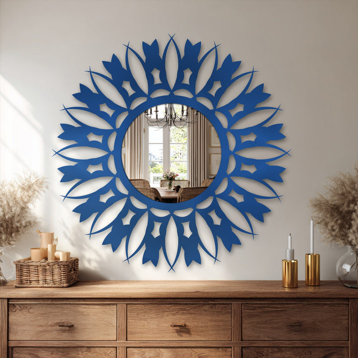 Elaborate floral sunburst mirror featuring a bold blue frame creates a striking border for decorating with wall mirrors.