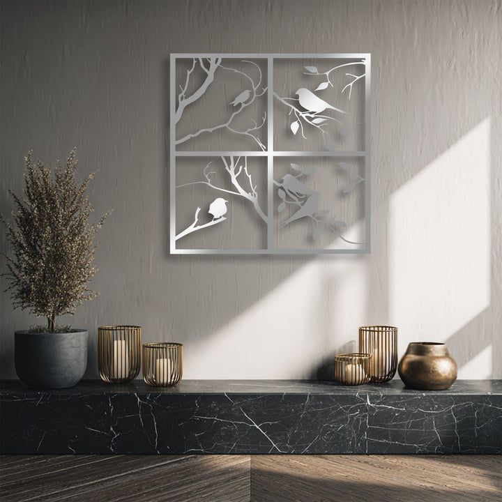 The striking color contrast highlights the gleaming four panel bird silhouette unique metal wall art against the muted wall and dark marble.